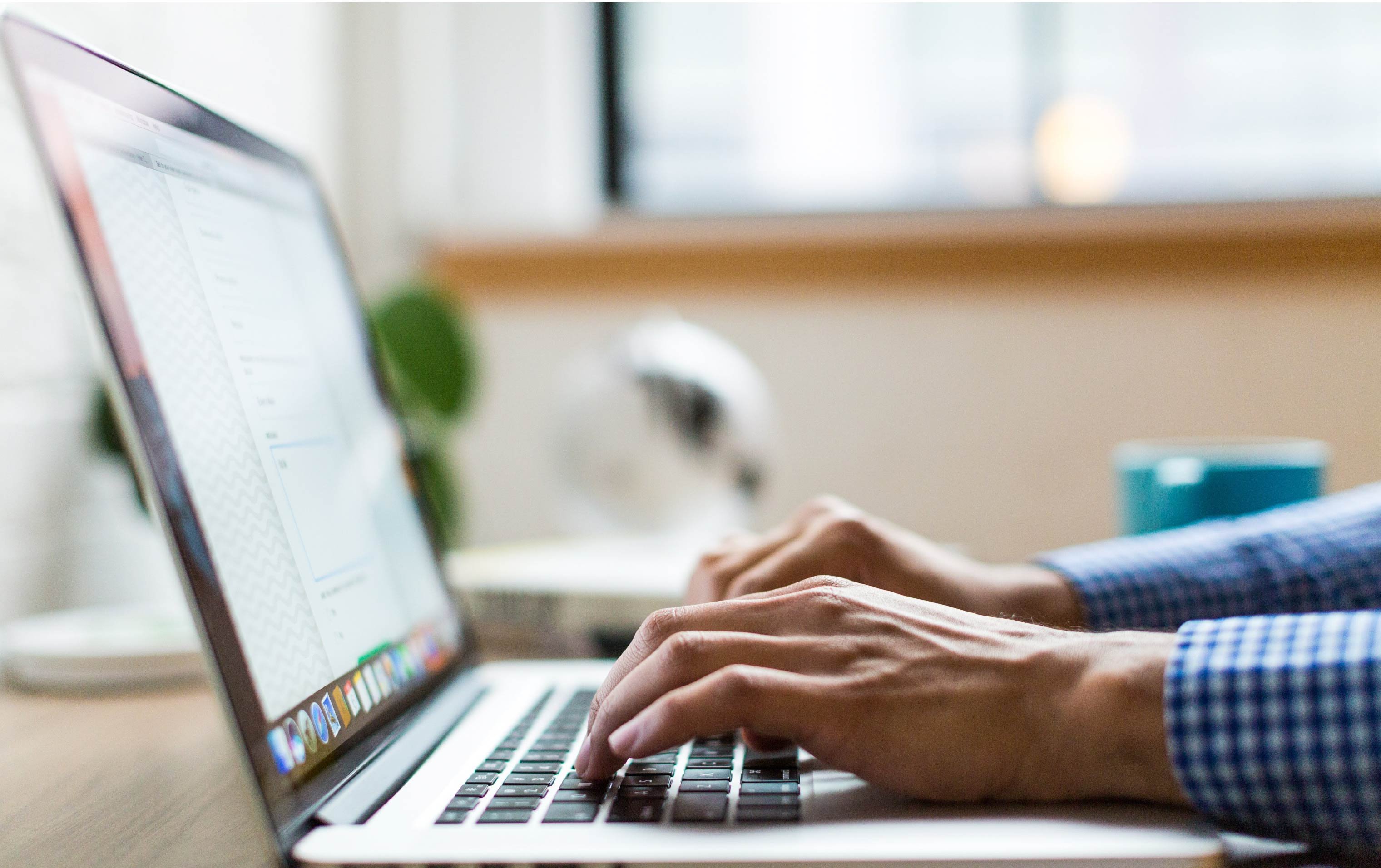 A man viewing a redesigned WordPress website on his laptop